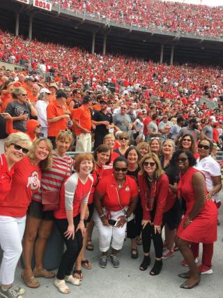 Group of the Glass Breakers at OSU football game with crowd behind them